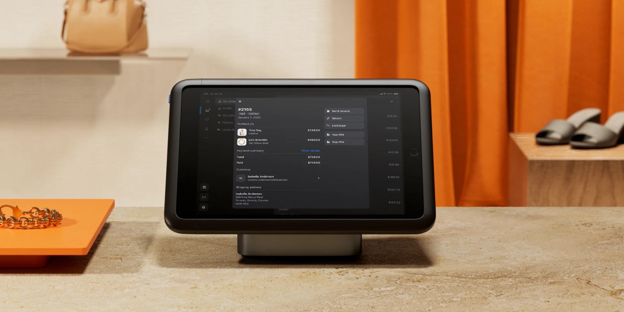Shopify POS terminal on a retail counter showing an order with payment summary